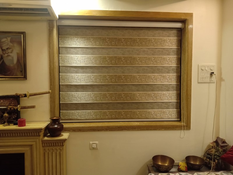 Beige zebra blind in a wooden window frame