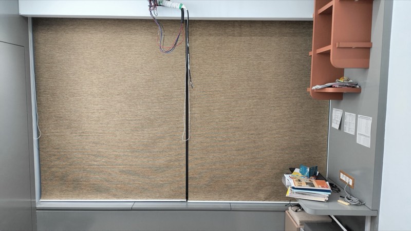 Sand-coloured roller blind in a kids' study